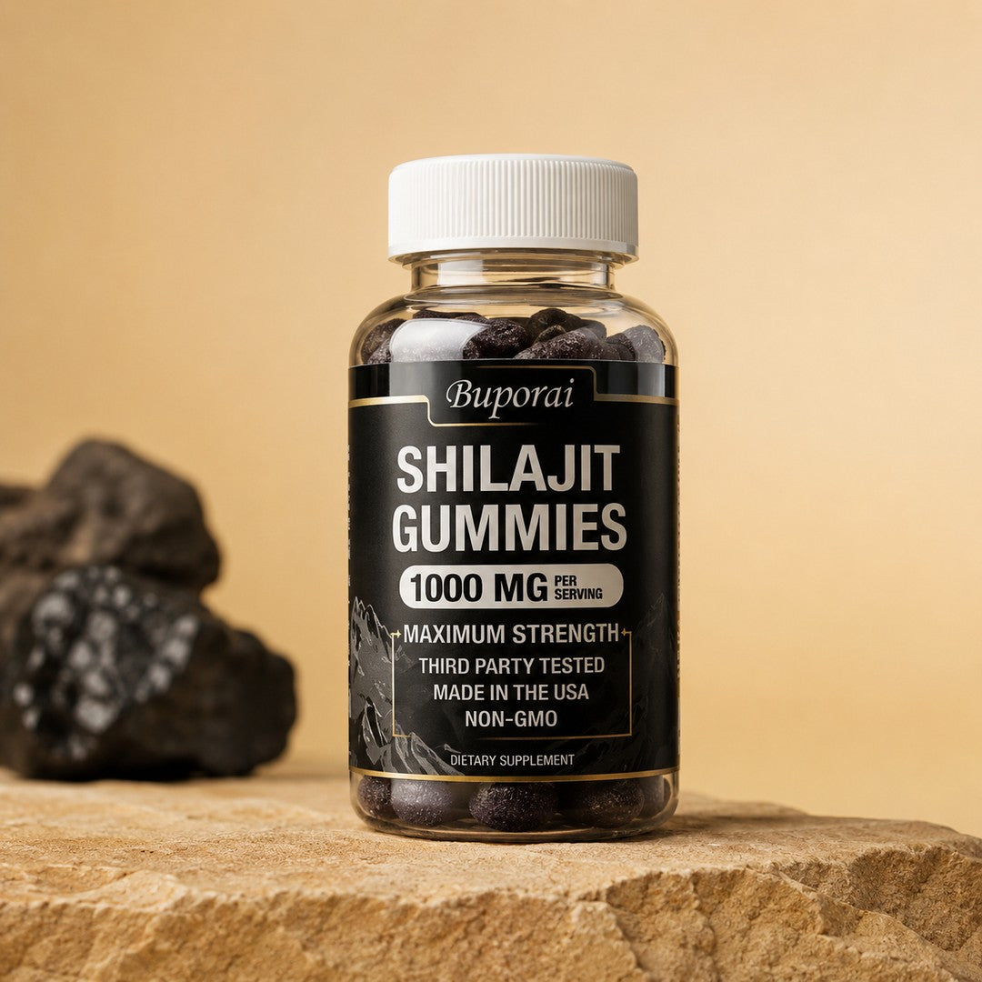 Frasco de Shilajit Gomitas 1000 mg por dosis, etiqueta negra y dorada, junto a rocas minerales